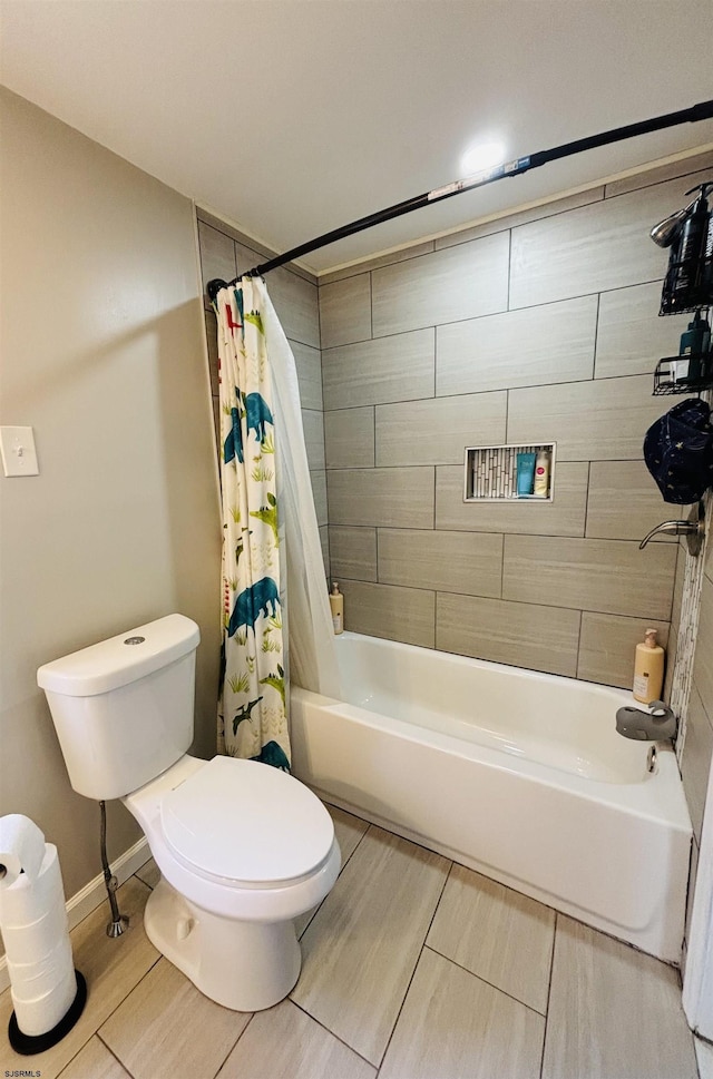 bathroom featuring shower / bath combination with curtain, baseboards, and toilet