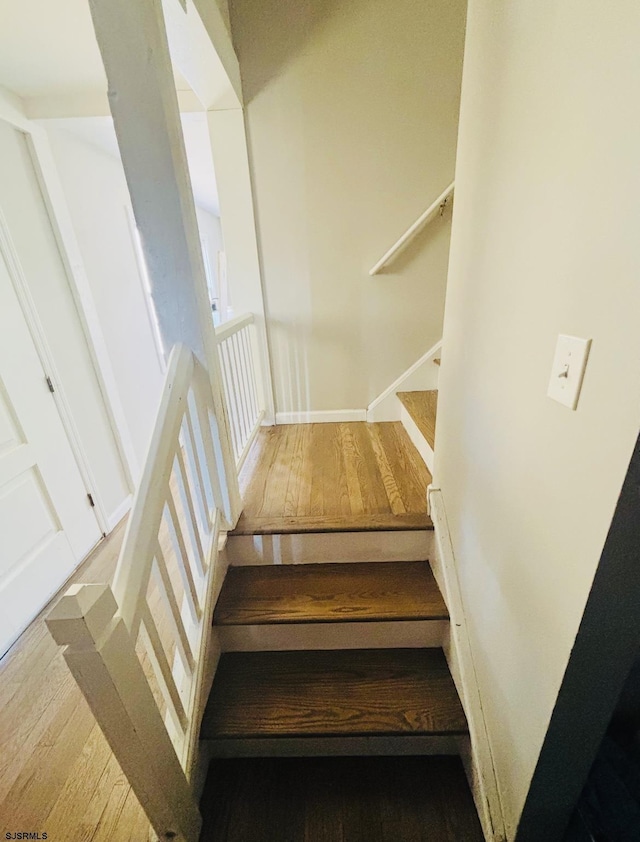 stairway featuring wood finished floors