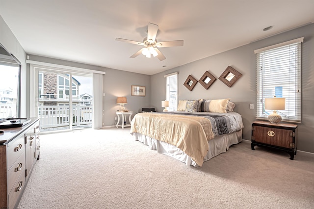 bedroom featuring light carpet, access to outside, multiple windows, and a ceiling fan