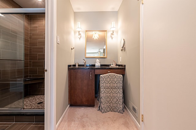 full bath with a shower stall, baseboards, and vanity