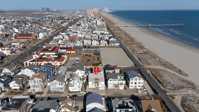 birds eye view of property with a beach view, a water view, and a residential view