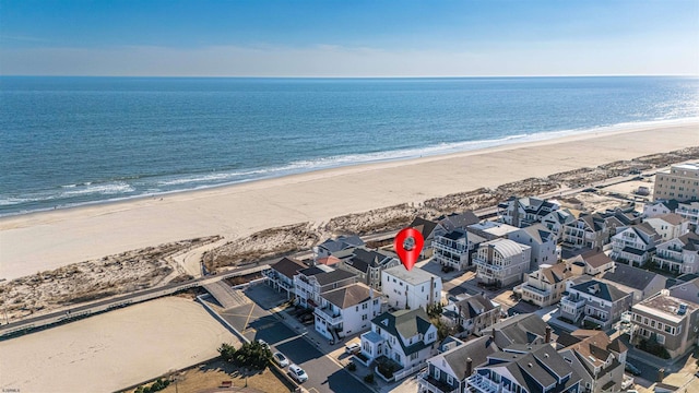 drone / aerial view with a water view and a view of the beach