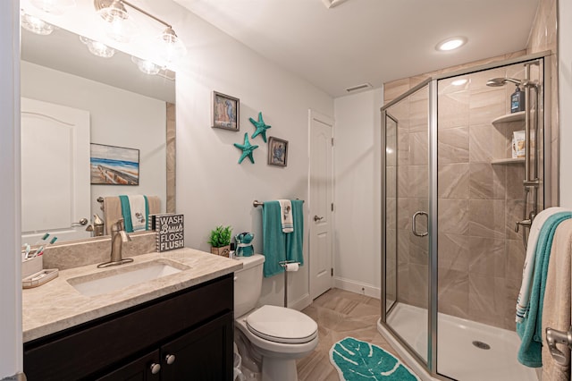 full bathroom with a stall shower, visible vents, vanity, and toilet