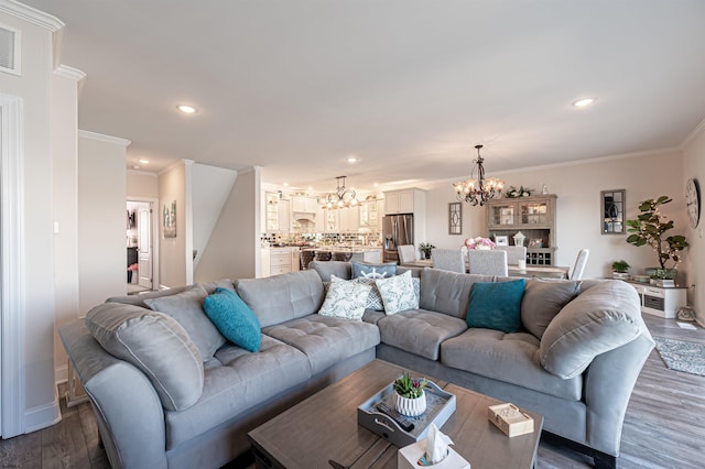 living area featuring crown molding, a chandelier, dark wood-type flooring, and recessed lighting