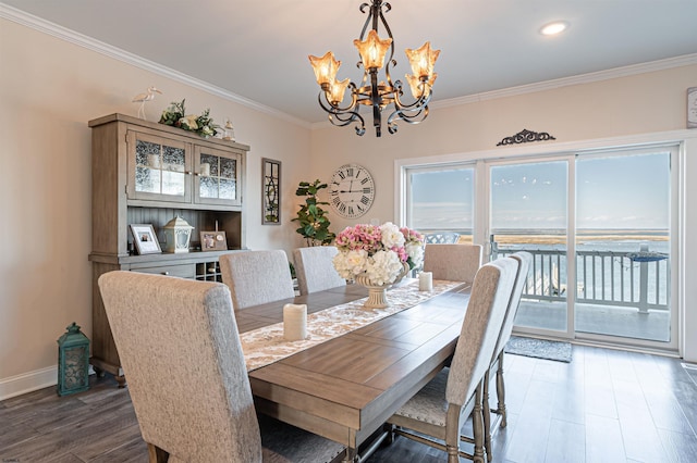 dining space featuring baseboards, ornamental molding, wood finished floors, a notable chandelier, and recessed lighting