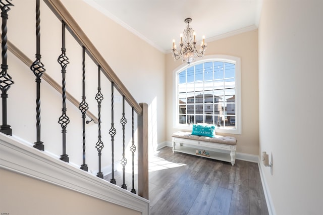 interior space with baseboards, hardwood / wood-style floors, stairs, crown molding, and a chandelier