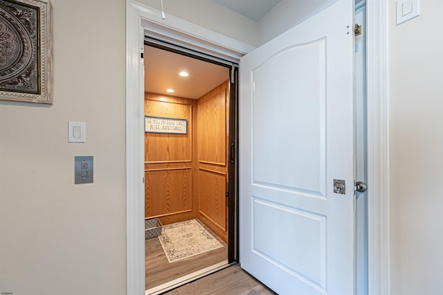 room details with recessed lighting, wood finished floors, and elevator