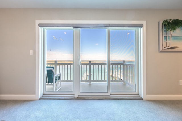 spare room featuring carpet flooring and baseboards