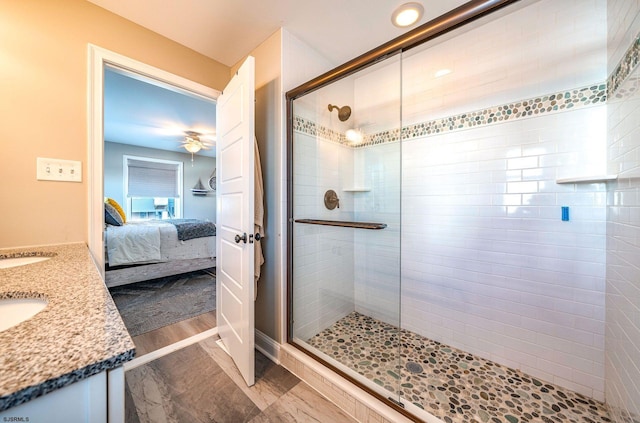 bathroom featuring wood finished floors, a stall shower, ensuite bath, and vanity