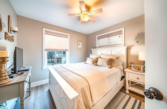 bedroom featuring dark wood finished floors, baseboards, and ceiling fan