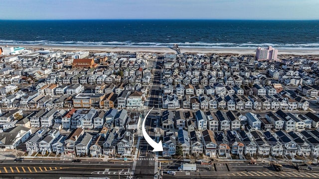 birds eye view of property with a beach view, a water view, and a residential view