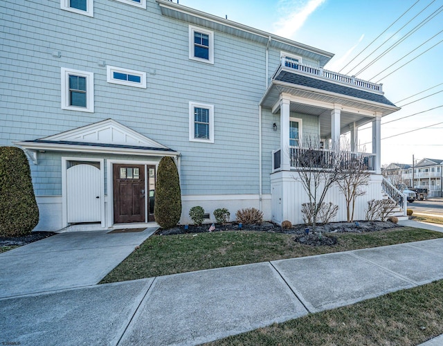 view of front of property featuring covered porch and stairs