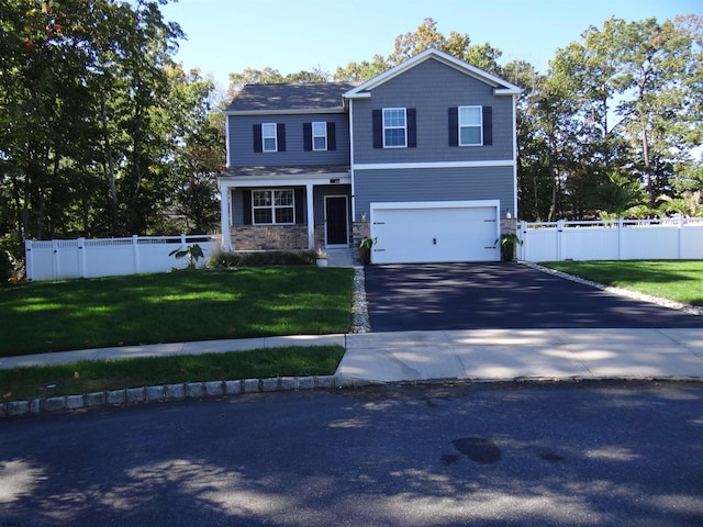 view of front of property with aphalt driveway, an attached garage, fence, a gate, and a front lawn