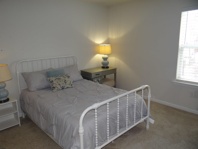 bedroom featuring baseboards and carpet flooring