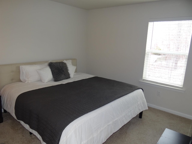 bedroom featuring baseboards and carpet flooring