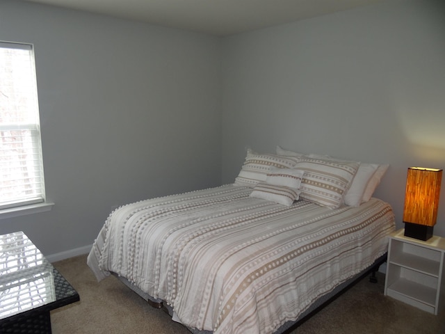 carpeted bedroom with baseboards