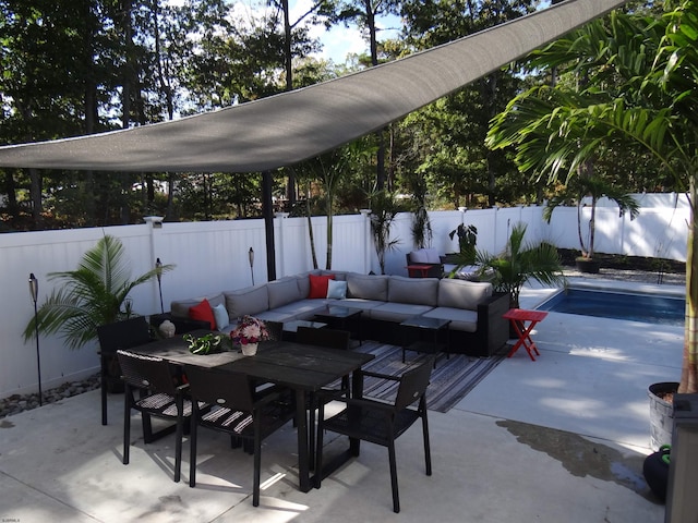 view of patio / terrace featuring outdoor dining area, a fenced backyard, and an outdoor hangout area