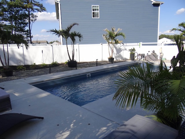 view of swimming pool featuring a patio area, a fenced backyard, and a fenced in pool