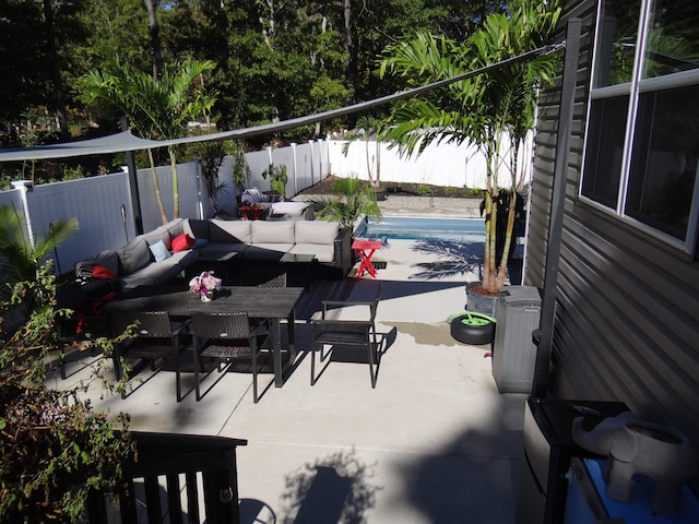 view of patio / terrace featuring a fenced in pool, outdoor dining area, a fenced backyard, and an outdoor living space