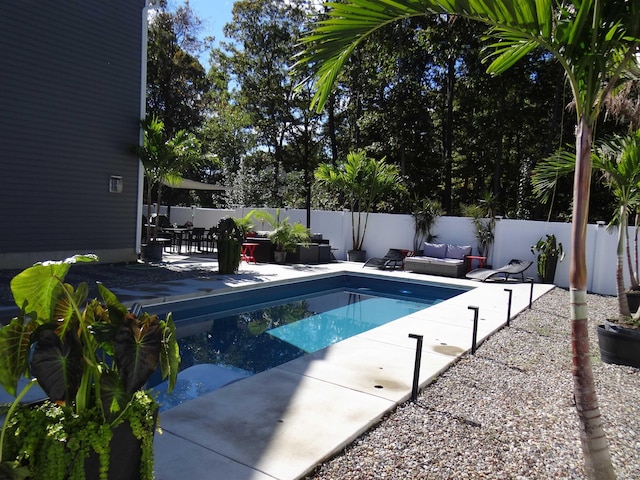 view of pool with a patio, outdoor lounge area, a fenced backyard, and a fenced in pool