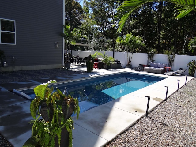 view of pool featuring an outdoor hangout area, a patio area, a fenced backyard, and a fenced in pool