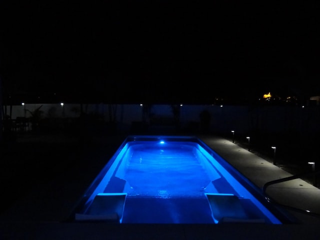 view of pool at night