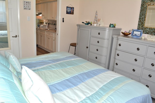 bedroom featuring a sink and ensuite bath