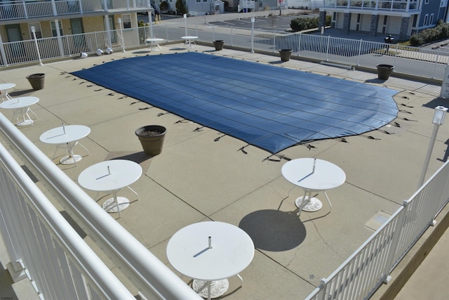 community pool featuring a patio and fence