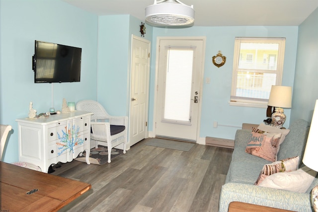 interior space with baseboards, baseboard heating, and wood finished floors