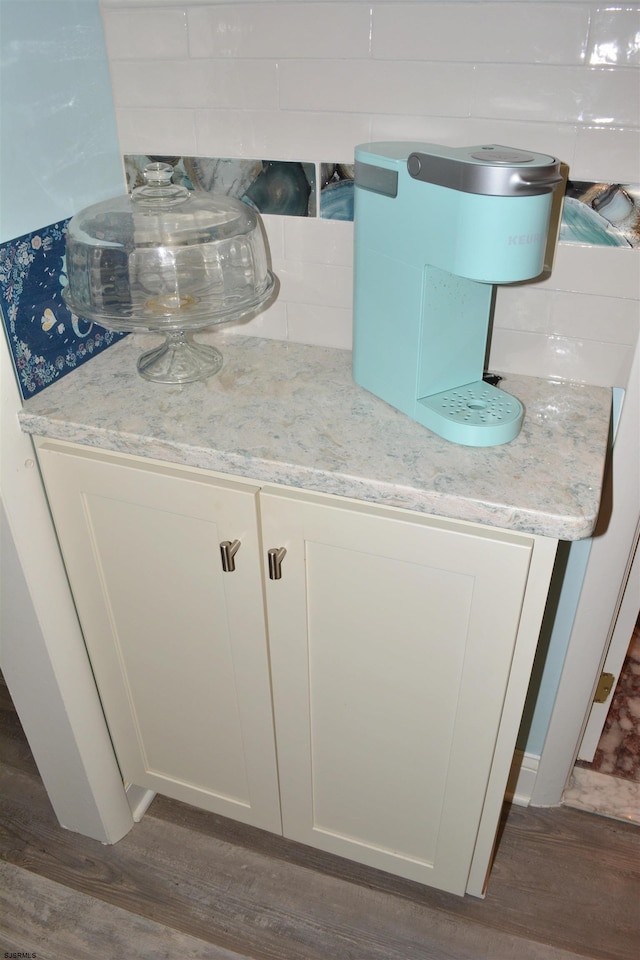 interior details with decorative backsplash and wood finished floors