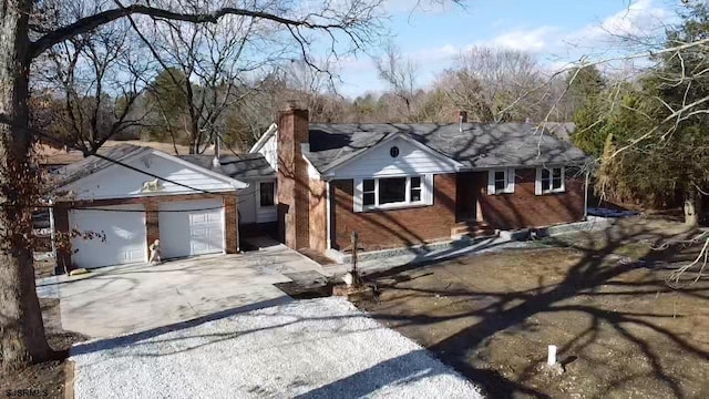 single story home featuring brick siding, driveway, a chimney, and entry steps