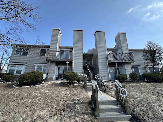 rear view of property featuring a chimney