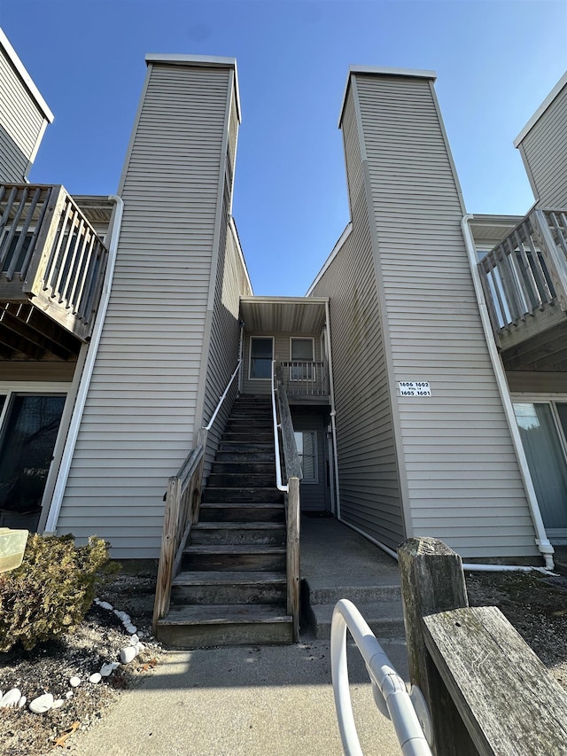 view of side of property featuring stairs and a chimney