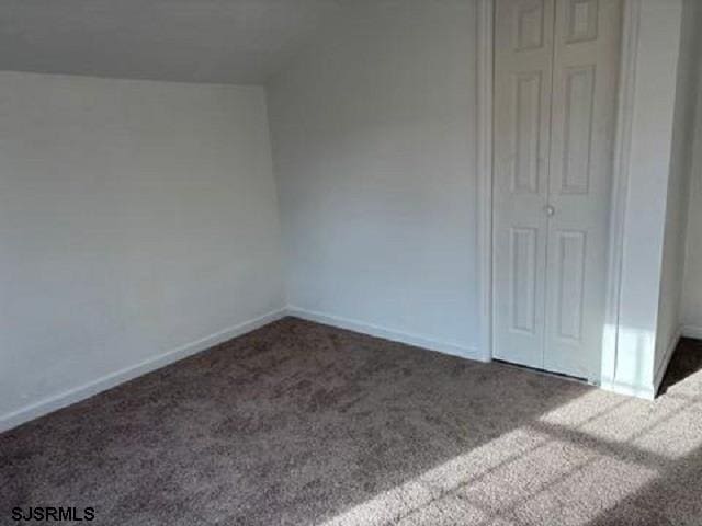 unfurnished bedroom with carpet floors and baseboards