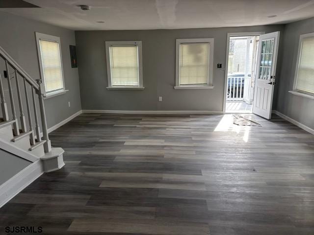 interior space featuring stairway, baseboards, and wood finished floors