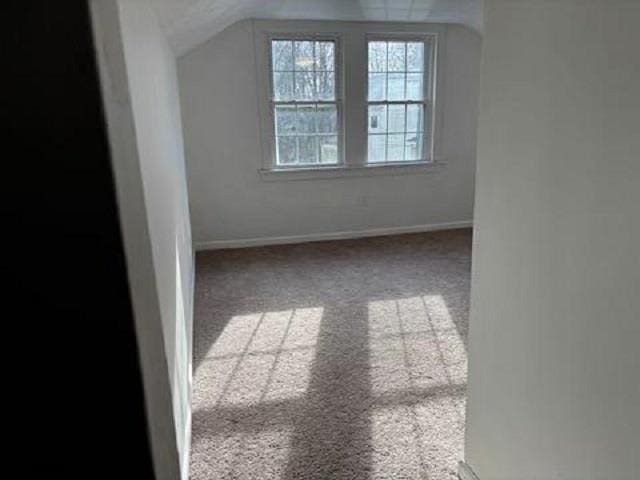 bonus room featuring vaulted ceiling, carpet floors, and baseboards