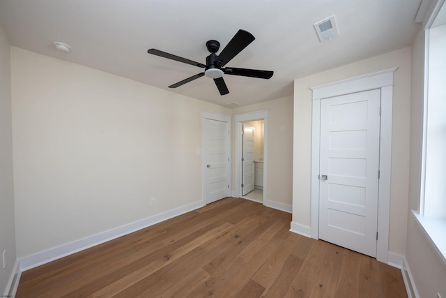 unfurnished bedroom featuring light wood-style floors, visible vents, and baseboards