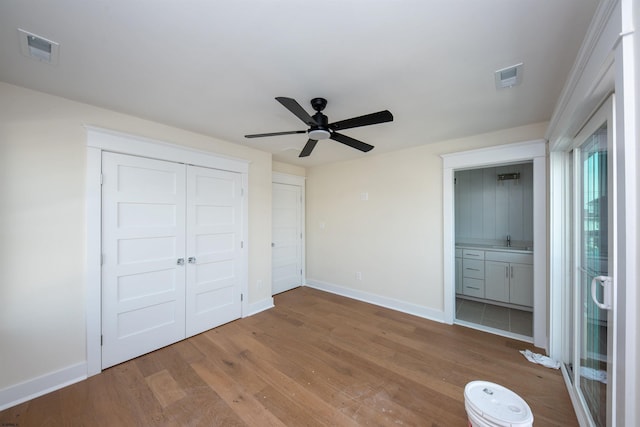 unfurnished bedroom with baseboards, visible vents, and light wood-style floors