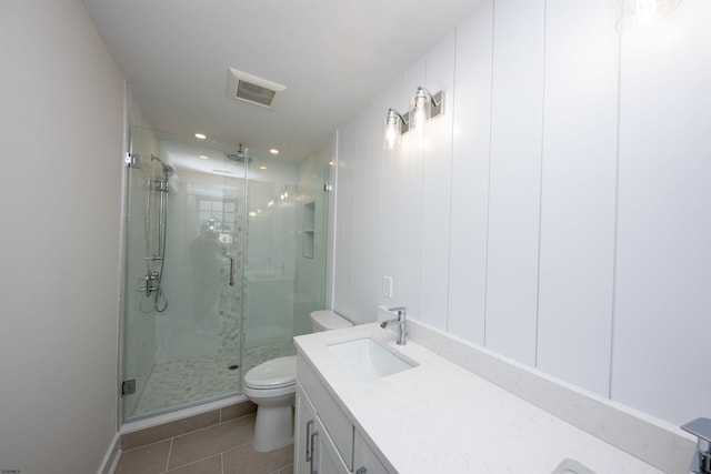 full bath featuring toilet, visible vents, vanity, a shower stall, and tile patterned floors