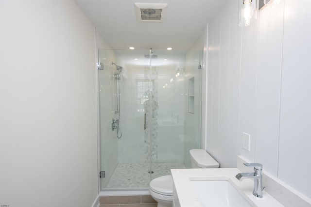 full bathroom with a stall shower, visible vents, toilet, tile patterned flooring, and vanity