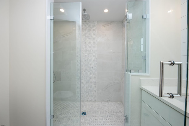 bathroom featuring a shower stall, vanity, and recessed lighting