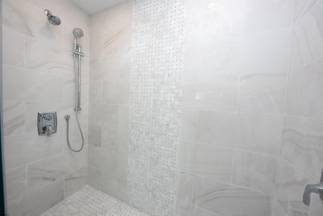 full bath featuring tiled shower