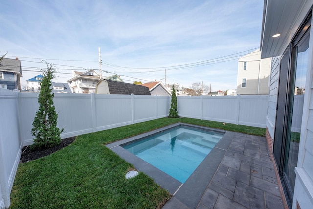 view of pool featuring a fenced backyard and a yard