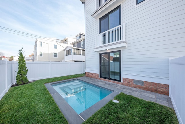 view of pool featuring a yard, a fenced backyard, and a residential view