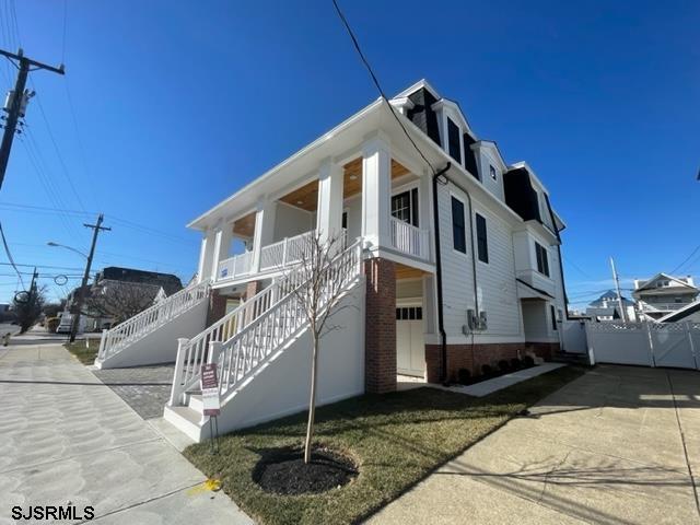 exterior space featuring covered porch and stairs