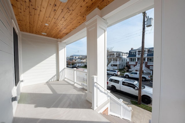 balcony featuring covered porch and a residential view