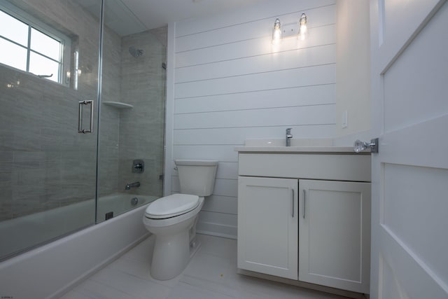 full bathroom with toilet, shower / bath combination with glass door, and vanity