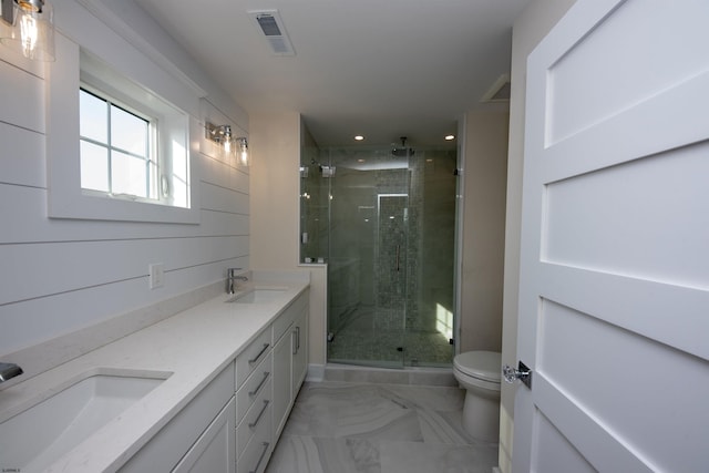 bathroom featuring toilet, marble finish floor, visible vents, and a sink