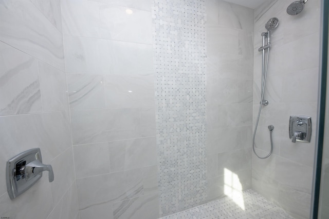 full bath featuring a tile shower