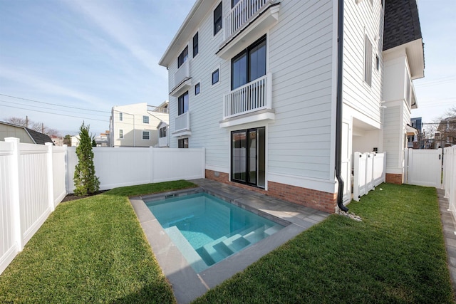 view of pool with a yard and a fenced backyard